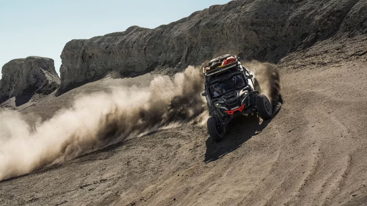 Can-Am Maverick R sport side-by-side sliding through a dune bowl